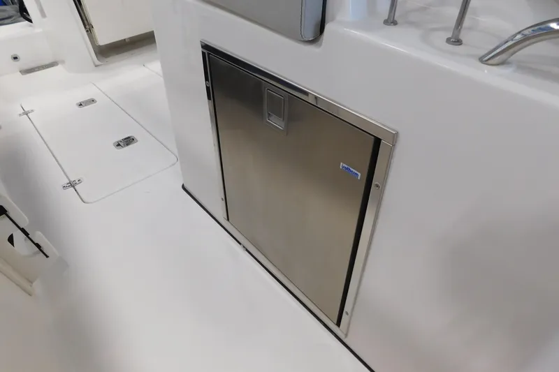 Slide: The Image of 2022 Pursuit S 328 Sport boat interior with stainless steel storage compartment. - 57