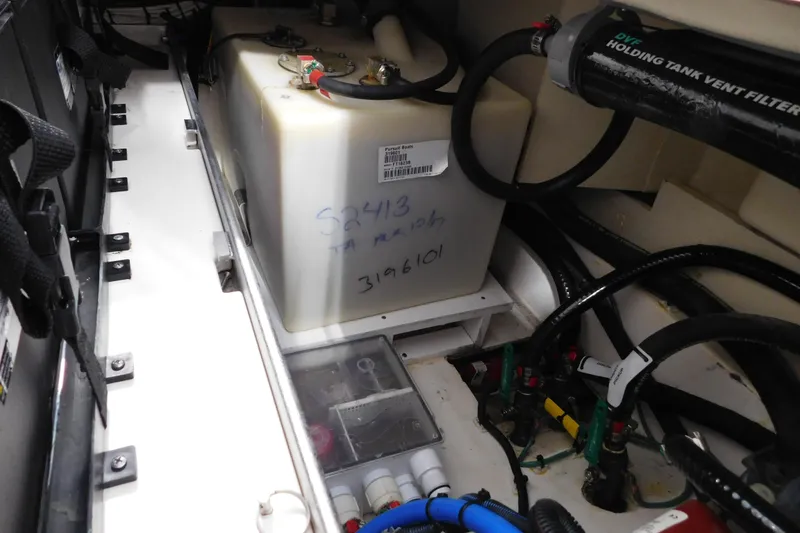 Slide: The Image of 2022 Pursuit S 328 Sport boat interior showing holding tank and vent filter system. - 61