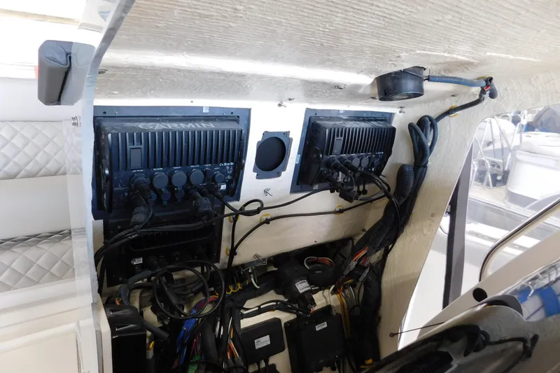 Slide: The Image of 2022 Pursuit S 328 Sport boat electronics panel with Garmin devices and wiring. - 64