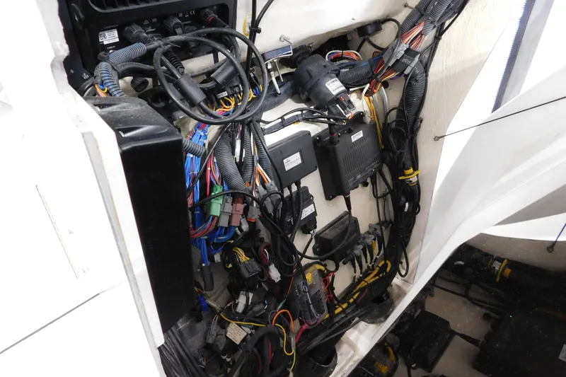 Slide: The Image of 2022 Pursuit S 328 Sport boat wiring and electrical components in engine compartment. - 65