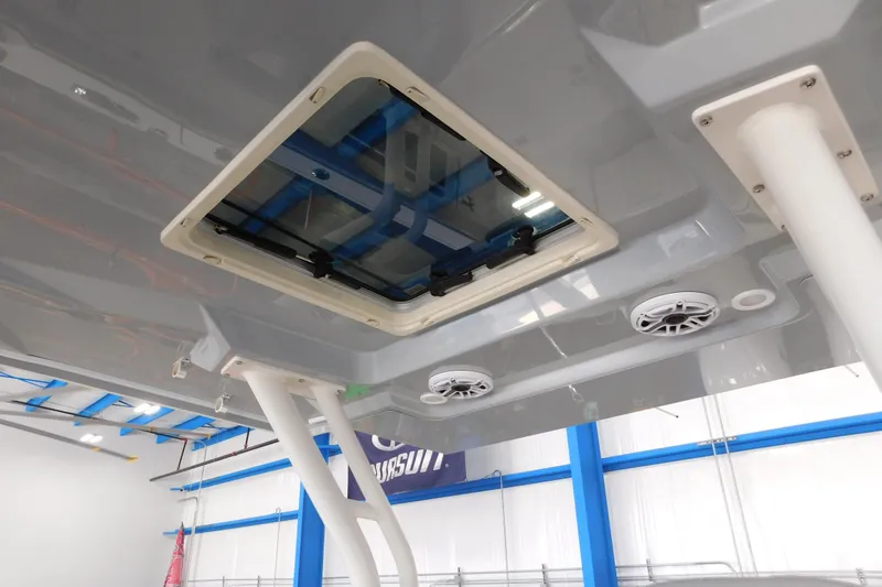 Slide: The Image of 2022 Pursuit S 328 Sport boat interior, featuring a hatch and speakers in a modern design. - 66