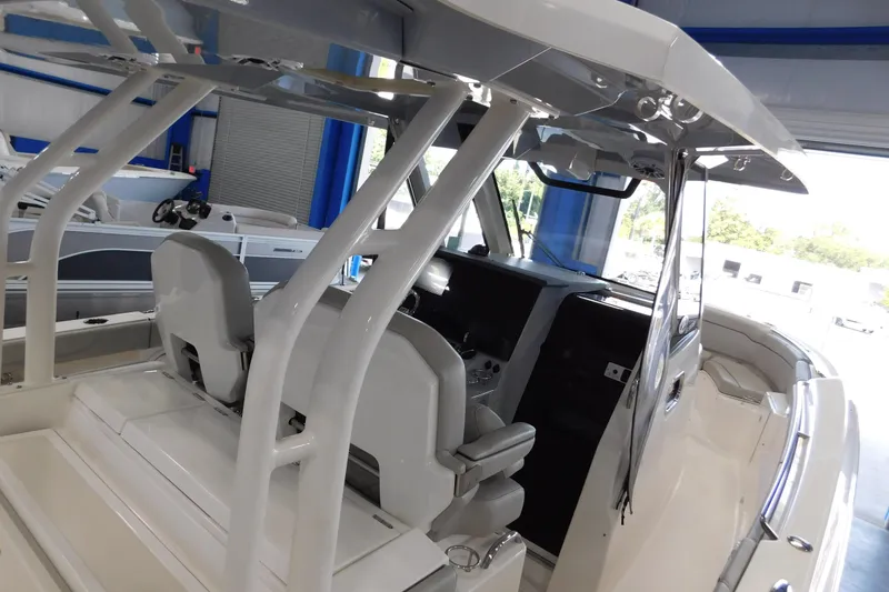 Slide: The Image of 2022 Pursuit S 328 Sport boat interior with seating and helm station. - 69