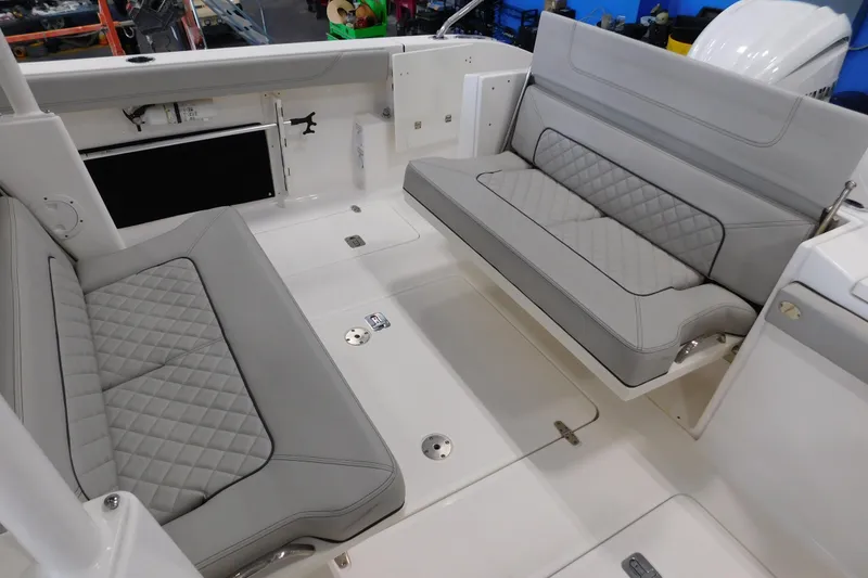 Slide: The Image of 2022 Pursuit S 328 Sport boat interior with gray quilted seating. - 7
