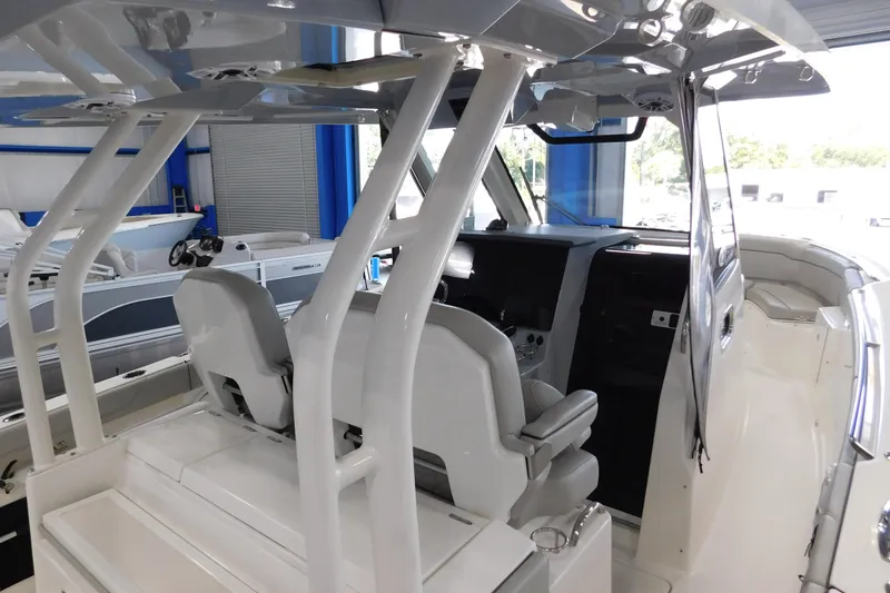 Slide: The Image of 2022 Pursuit S 328 Sport boat interior with helm and seating area. - 70