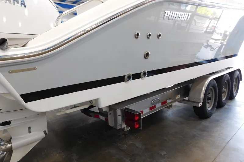 Slide: The Image of 2022 Pursuit S 328 Sport boat on a trailer in a showroom. - 72