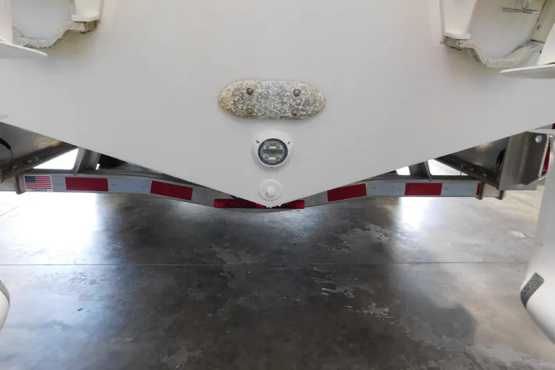 Slide: The Image of Rear view of a 2022 Pursuit S 328 Sport boat on a trailer indoors. - 75