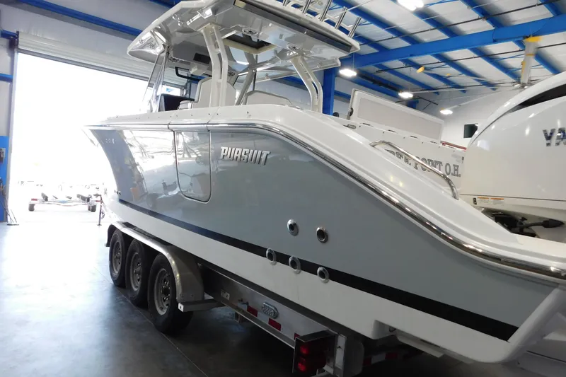 Slide: The Image of 2022 Pursuit S 328 Sport boat on trailer in indoor showroom. - 78