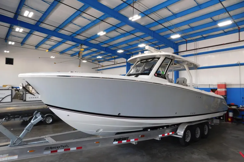 Slide: The Image of 2022 Pursuit S 328 Sport boat on trailer in indoor facility. - 82