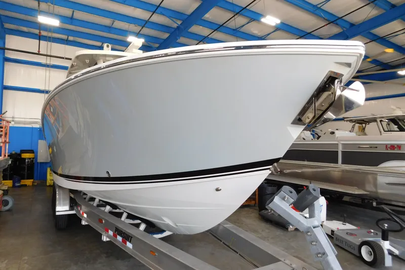 Slide: The Image of 2022 Pursuit S 328 Sport boat in indoor storage on a trailer. - 84