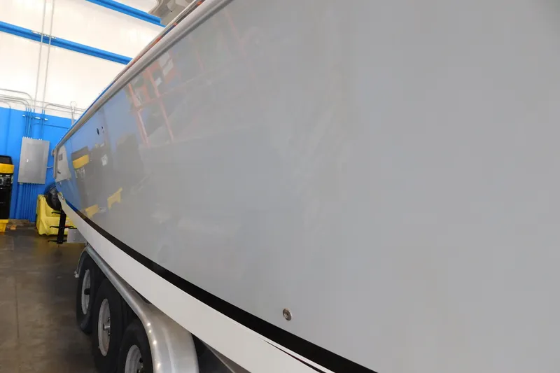 Slide: The Image of 2022 Pursuit S 328 Sport boat on trailer in indoor storage facility. - 86