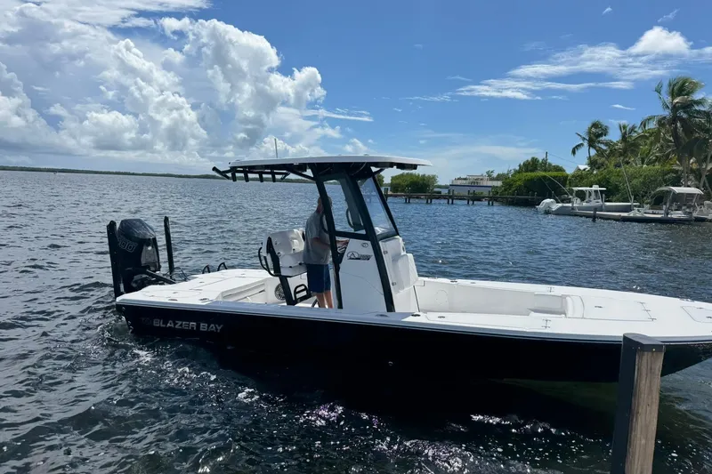 Slide: The Image of 2026 Blazer 2550 GTS boat on water, clear sky, palm trees in background. - 10