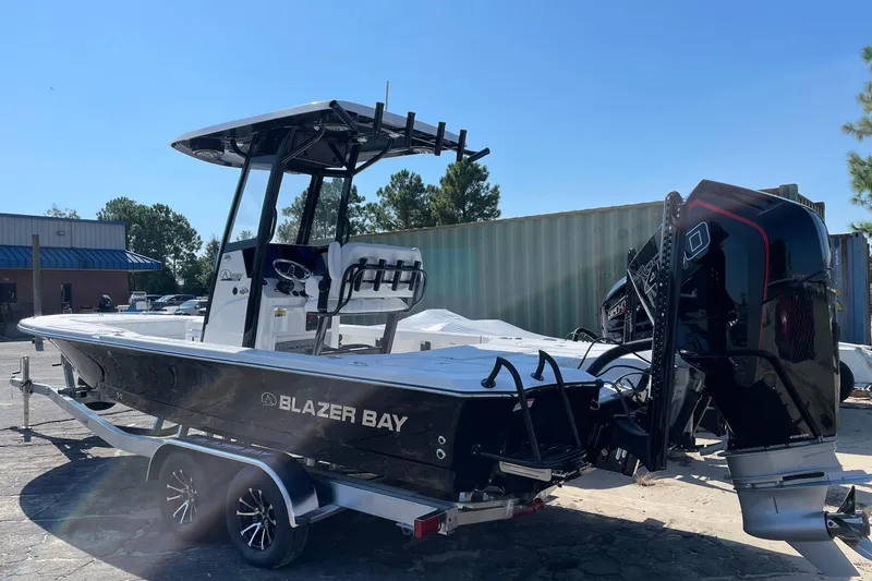 Slide: The Image of 2026 Blazer 2550 GTS boat on trailer, outdoor setting, sunny day. - 12