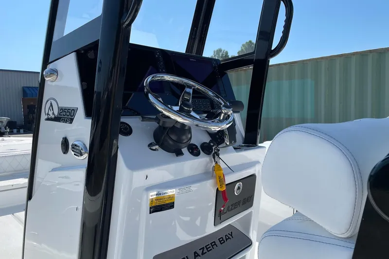 Slide: The Image of 2026 Blazer 2550 GTS boat console with steering wheel and controls. - 14