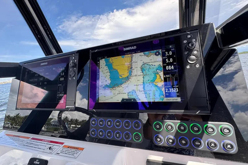 Slide: The Image of 2026 Blazer 2550 GTS boat dashboard with Simrad navigation system and control panel. - 2