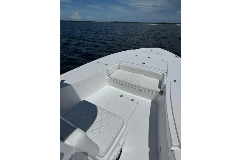 Slide: The Image of 2026 Blazer 2550 GTS boat interior with white seating on open water. - 7