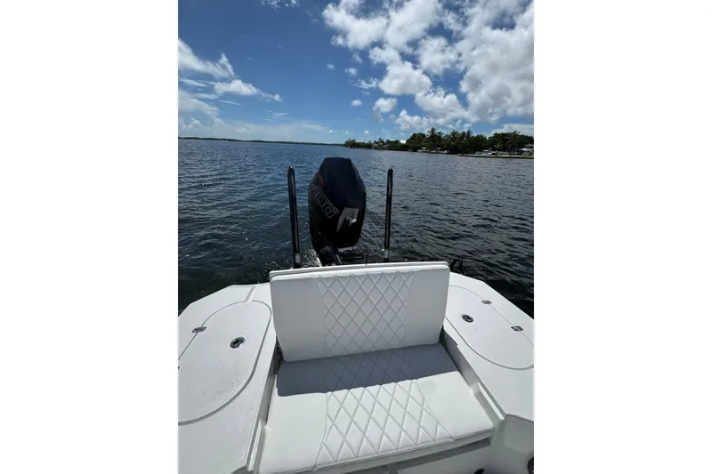 Slide: The Image of 2026 Blazer 2550 GTS boat on water, featuring white seating and outboard motor. - 9