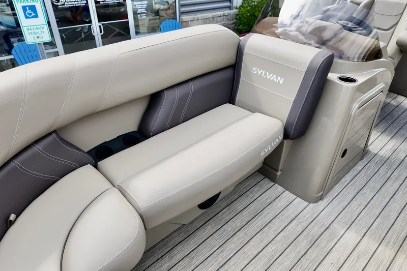 Slide: The Image of 2026 Sylvan Mirage 822 LZ boat interior with beige seating and cup holders. - 10