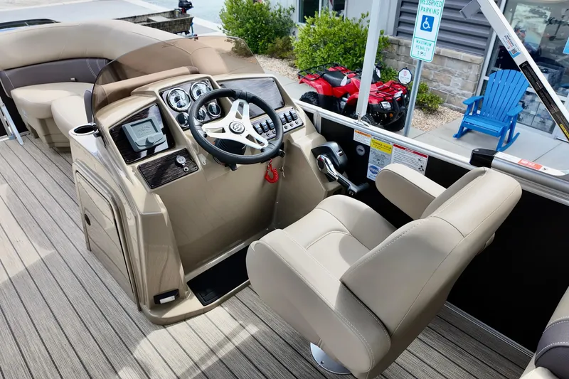 Slide: The Image of Captain's helm of 2026 Sylvan Mirage 822 LZ pontoon boat with beige seating and controls. - 6