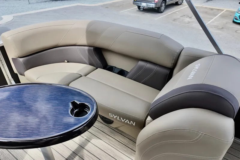 Slide: The Image of Luxurious seating on 2026 Sylvan Mirage 822 LZ pontoon boat with sleek table design. - 7