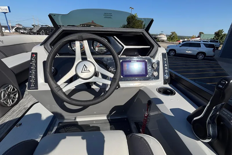 Slide: The Image of 2026 Viaggio Z24U boat dashboard with steering wheel, control panel, and navigation display. - 19