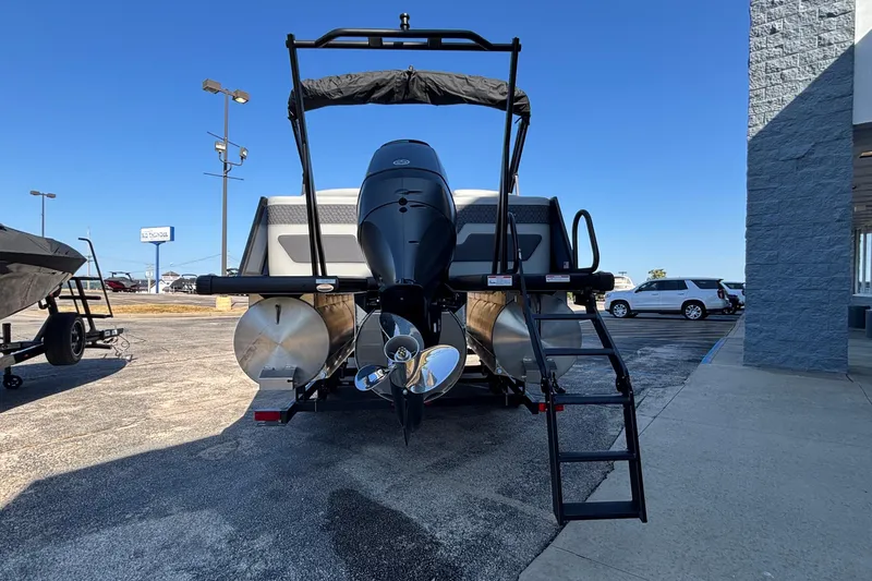 Slide: The Image of 2026 Viaggio Z24U pontoon boat with outboard motor and ladder, parked outdoors. - 4