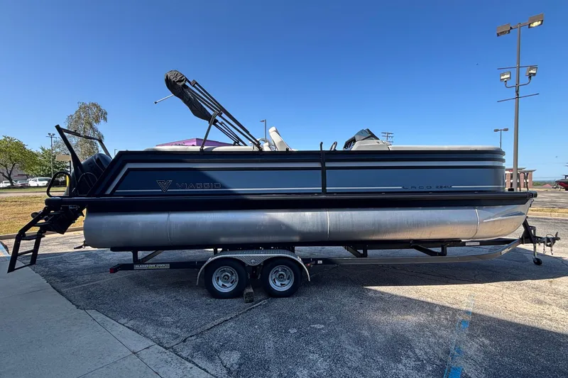 Slide: The Image of 2026 Viaggio Z24U pontoon boat on trailer under clear blue sky. - 6