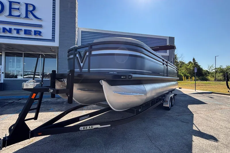 Slide: The Image of 2026 Viaggio Z24U pontoon boat on trailer outside dealership. - 9