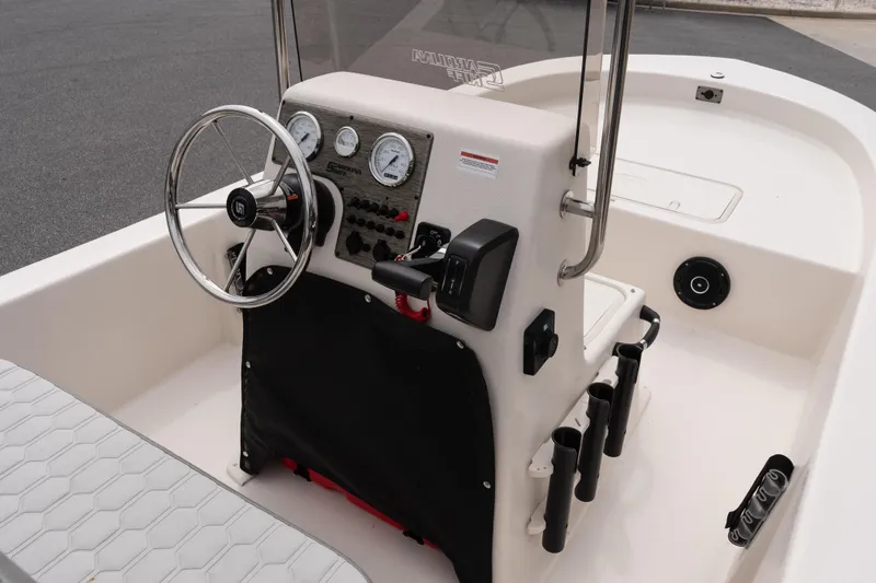 Slide: The Image of 2026 Carolina Skiff E18 JVX CC boat console with steering wheel and gauges. - 11