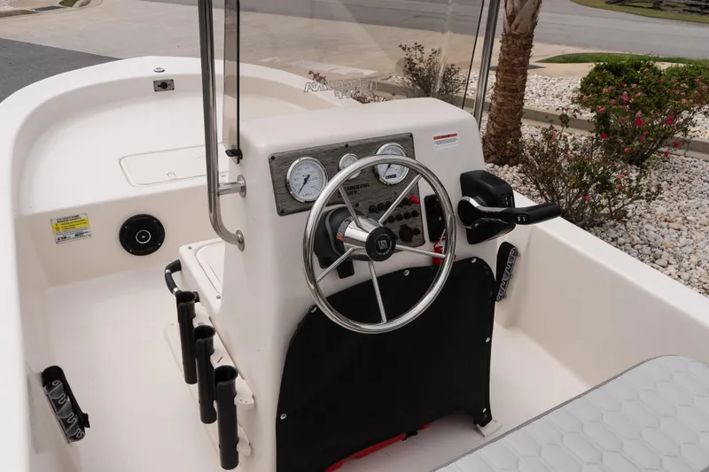 Slide: The Image of 2026 Carolina Skiff E18 JVX CC boat console with steering wheel and controls. - 12