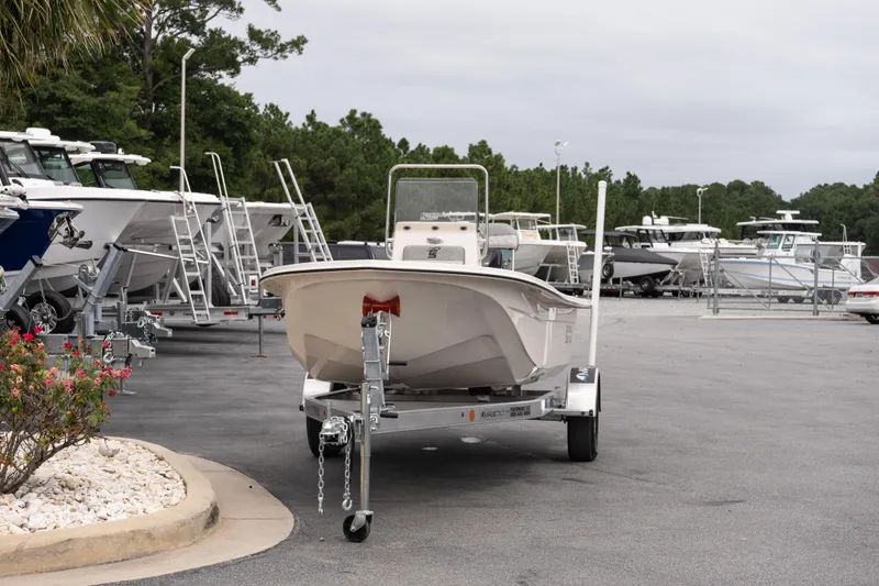 Slide: The Image of 2026 Carolina Skiff E18 JVX CC boat on trailer in dealership lot. - 3