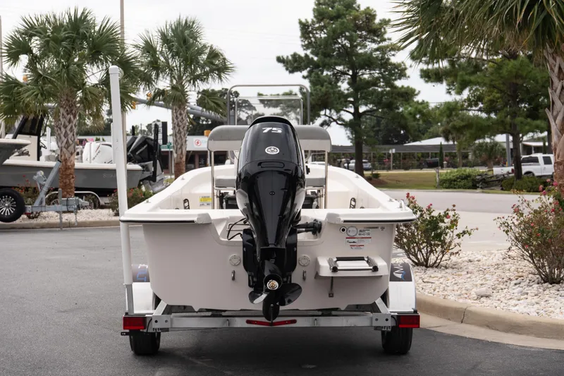 Slide: The Image of 2026 Carolina Skiff E18 JVX CC boat on trailer, rear view, outdoor setting. - 5