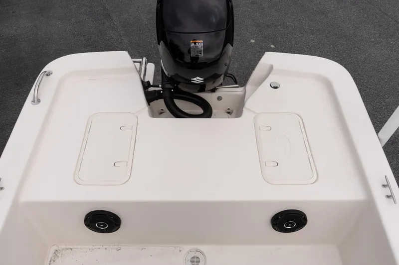 Slide: The Image of 2026 Carolina Skiff E18 JVX CC boat deck with motor and storage compartments. - 6