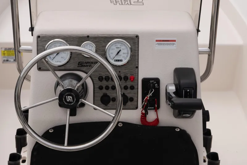 Slide: The Image of 2026 Carolina Skiff E18 JVX CC boat console with steering wheel and controls. - 8