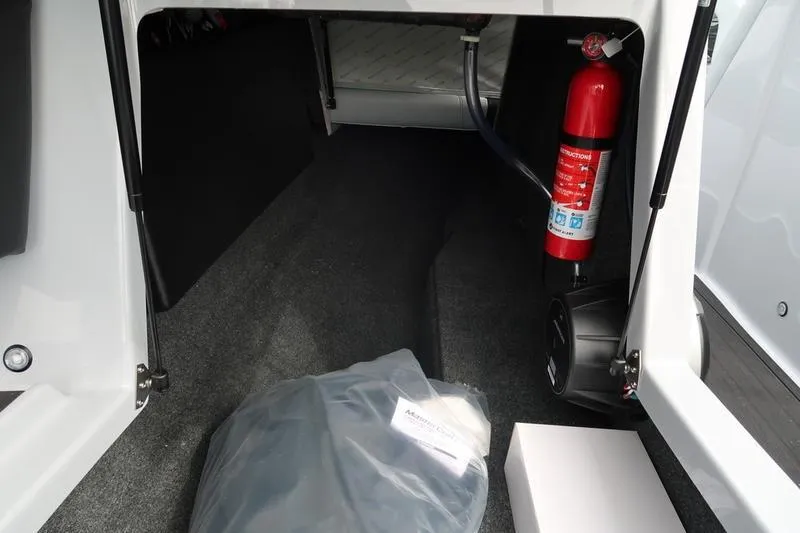 Slide: The Image of Blue 2026 MasterCraft NXT22 boat with chrome logo detail. - 12