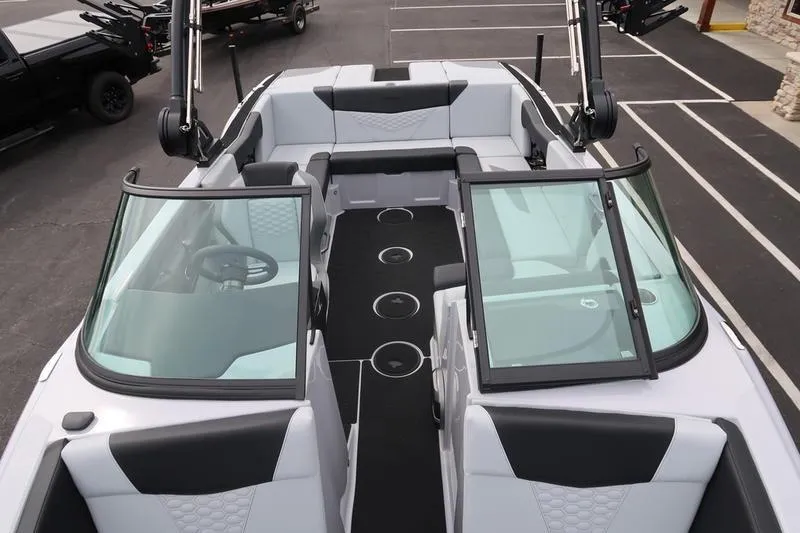 Slide: The Image of Open storage compartment in 2026 MasterCraft NXT22 boat, showcasing spacious interior. - 19