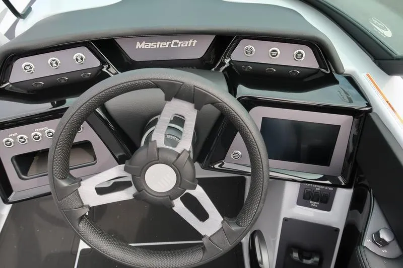 Slide: The Image of 2026 MasterCraft NXT22 capacity label: 14 persons or 2312 lbs, U.S. Coast Guard compliant. - 22