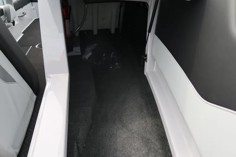 Slide: The Image of 2026 MasterCraft NXT22 interior storage compartment with carpeted flooring. - 25
