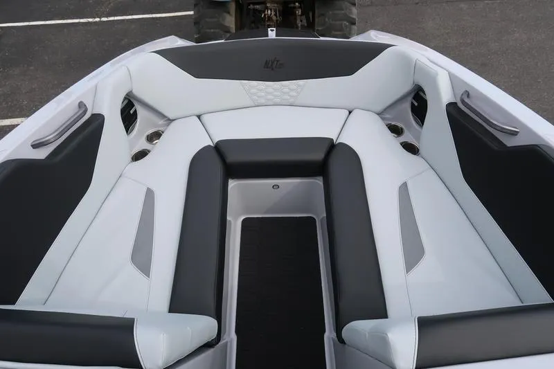 Slide: The Image of 2026 MasterCraft NXT22 boat interior with sleek black and white seating design. - 26