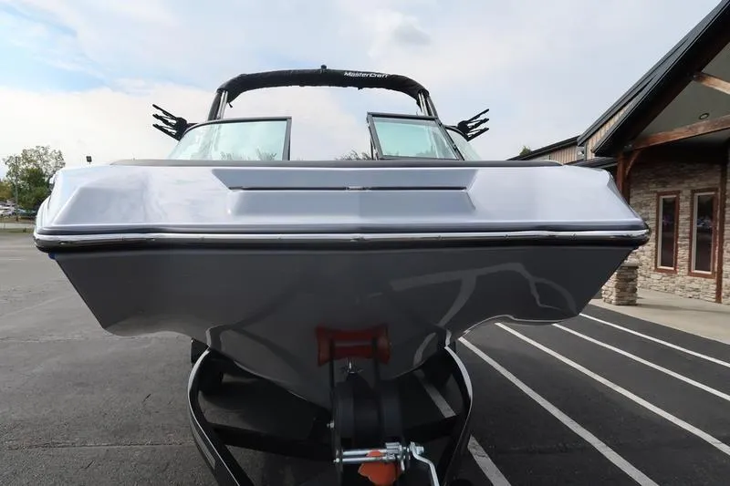 Slide: The Image of 2026 MasterCraft NXT22 boat on trailer outside dealership. - 4