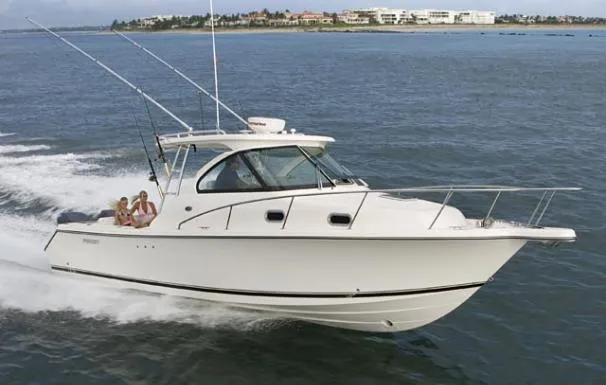 Slide: The Image of 2013 Pursuit OS 315 Offshore boat docked at a marina with Yamaha engines. - 1