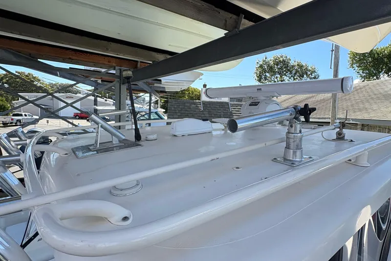 Slide: The Image of Manufacturer Provided Image: 2013 Pursuit OS 315 Offshore boat interior with white seating, cushion, and hat. - 14