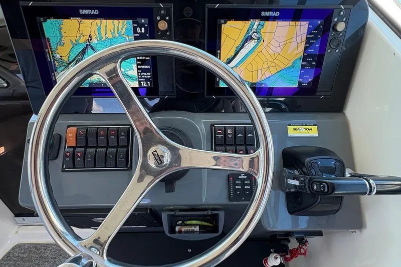 Slide: The Image of 2013 Pursuit OS 315 Offshore boat interior with helm and seating area. - 16
