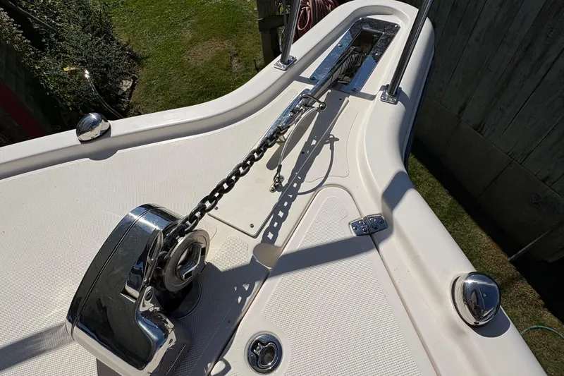 Slide: The Image of 2013 Pursuit OS 315 Offshore boat on trailer, showing hull and trim tabs. - 19