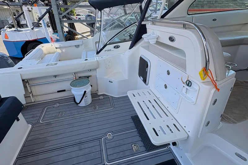 Slide: The Image of Manufacturer Provided Image: 2013 Pursuit OS 315 Offshore cabin interior with kitchenette, microwave, and cozy sleeping area. - 21