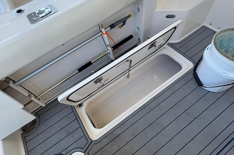 Slide: The Image of Close-up of a 2013 Pursuit OS 315 Offshore boat hull, showcasing sleek design. - 23