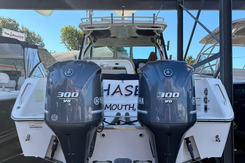 Slide: The Image of Interior of 2013 Pursuit OS 315 Offshore boat with wood paneling and fishing rods. - 27
