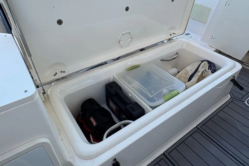 Slide: The Image of 2013 Pursuit OS 315 Offshore engine compartment with batteries and wiring. - 36