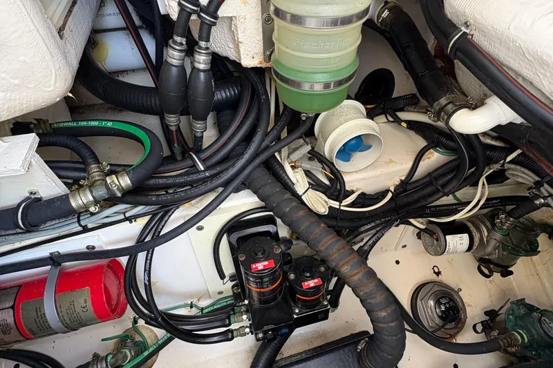 Slide: The Image of 2013 Pursuit OS 315 Offshore engine compartment with wiring and components. - 37