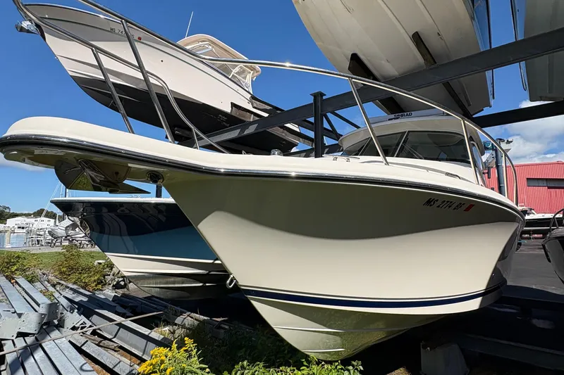 Slide: The Image of Engine compartment of a 2013 Pursuit OS 315 Offshore boat, showing hoses and components. - 38
