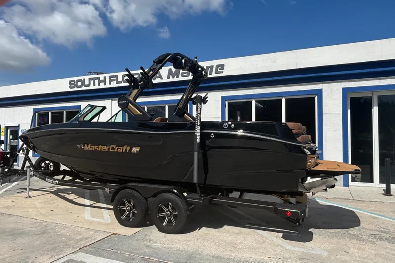 The Image of 2026 MasterCraft XT24 boat on trailer at South Florida Marine dealership. - 0